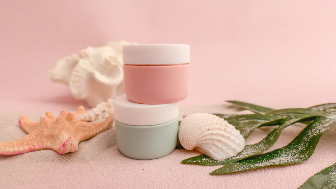 Close-up comparison of acrylic and glass cosmetic jars for skincare packaging